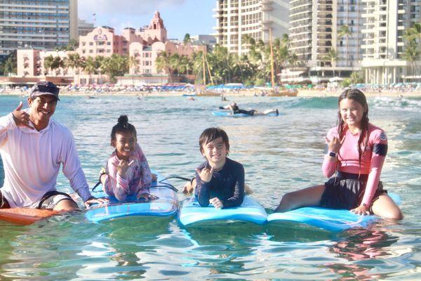 Lead instructor Isaiah sharing some waves with the next generation.