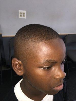 High an tight bald fade with lined front.