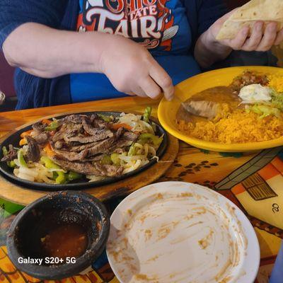 Steak fajitas, rice, refried beans