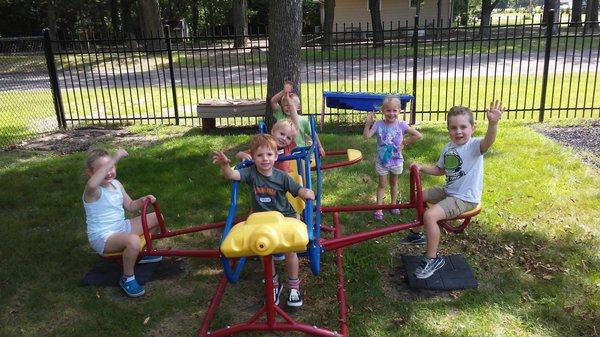 Children play together in our fenced in playground.