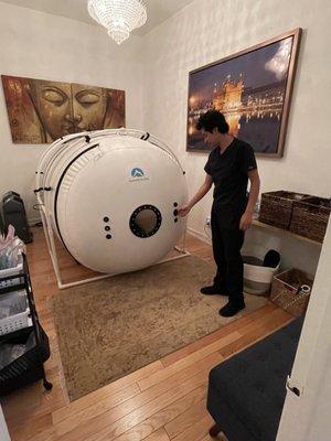 Aidan checking up on the Hyperbaric Chamber, a machine that provides direct oxygen to the body in a controlled space.