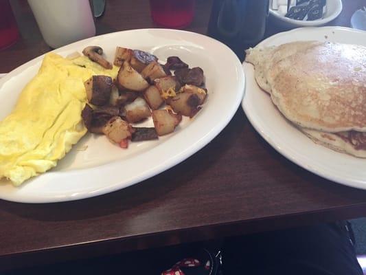 Garden omelet with a side of potatoes and a stack of pancakes