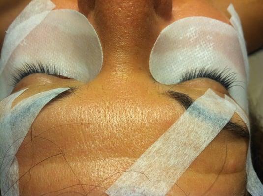 Process of getting eyelash extensions in the outer corners. Just started on my right eye