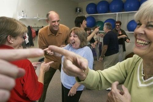 Participants engaged in Laughter Yoga program.