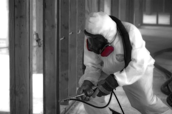 Technician soda-blasting affected framing