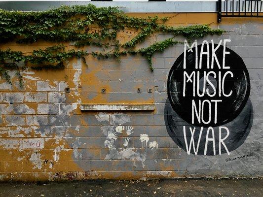 make music not war mural outside the shop