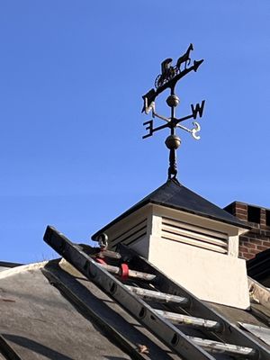 This is a custom built cupola using an antique Amish Main in Buggy weather vane.