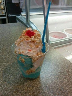 A 3 scoop sundae with cotton candy ice cream and vanilla.