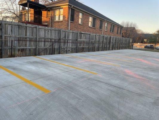 Graded the ground, poured the cement, and striped the lot.