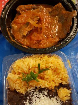 Bistec Encebollado with the included rice and black beans. Nicely presented for a delivery order.