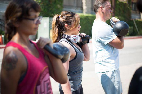 Semi private personal training clients using kettlebell carries for conditioning work outside the gym. http://strongmadesimple.com