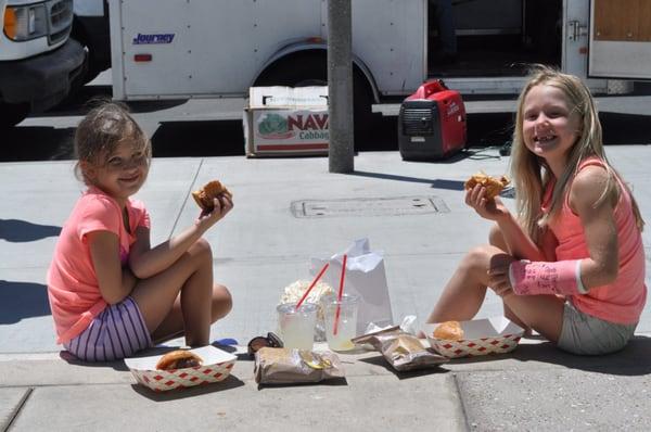 Girls enjoying kepner farms Burgers and Chicken Burgers.