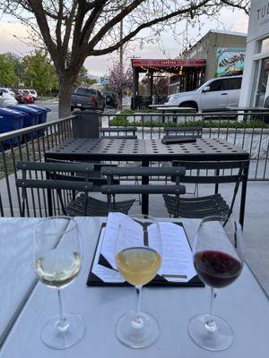 3 3 Oz pours of delicious wine at a table on the patio.