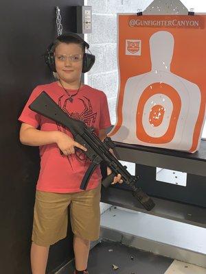 My sons first time, great grouping with the fully automatic MP5 9mm.