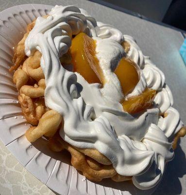 TRES LECHES FUNNEL CAKE with peaches on top