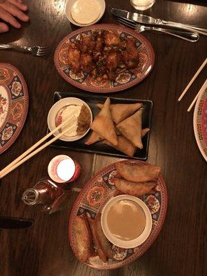 Bottom to top: Pretzel Pork and Chive Dumplings, Samosas, and Kung Pao Chicken Wings