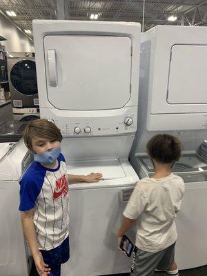 Boys picking out washer and dryer