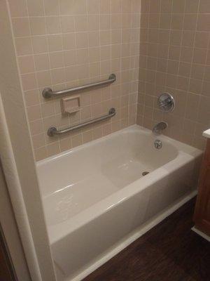 Grab bars installed in tub for ease of access.