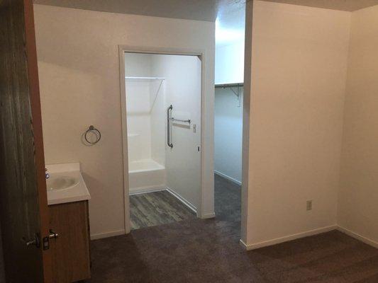 Bedroom bathroom with pocket doors for smooth privacy. Extended walk in closet