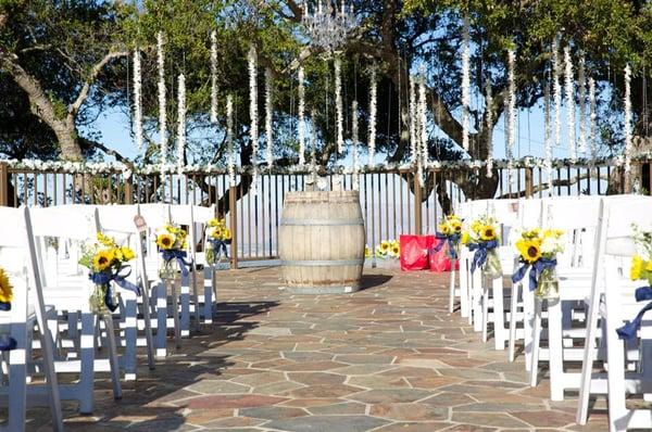 Hanging aisle mason jars filled with sunflowers for the Kandt Wedding :)