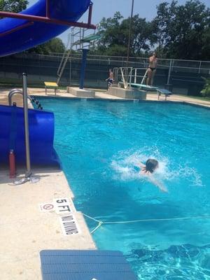 A cool slide, a diving board, and a high diving board.