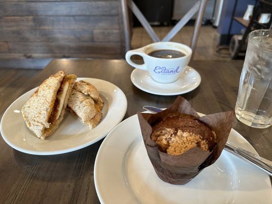 Breakfast sandwich, mixed berry muffin and a cup Americano coffee.