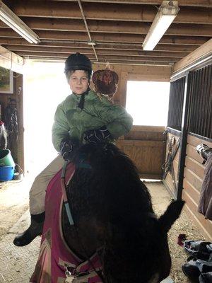 Bareback barn yoga with his favorite hen.