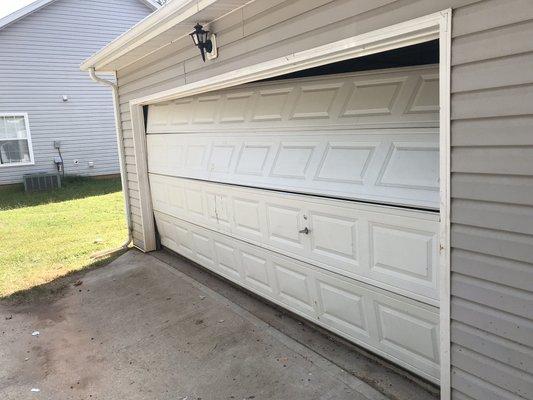 Garage door off track/ rollers off track. 
Don't replace it, repair it