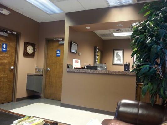 Looking towards their desk and restrooms sitting on a comfy couch.