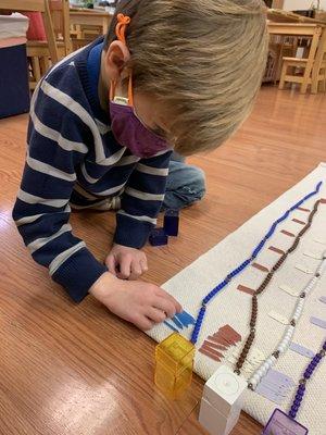 Montessori short beads chain practiced by a 41/2-year-old.