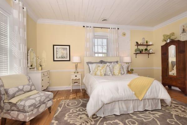 Our charming, window filled, Cottage room features a beautiful fireplace wall and brick hearth.