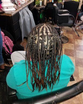 Half cornrows at the top single braids in the back