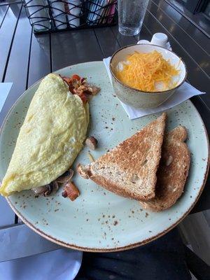 Hearty Omelette with cheese grits and wheat toast.