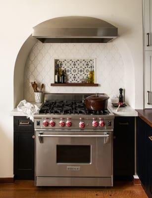 Stove set into an arch to match the Mediterranean style house.