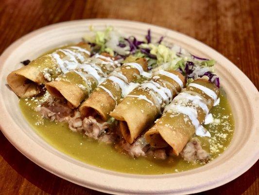 Flautas En Salsa acostados con Frijoles.