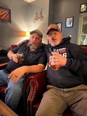 The husbands enjoying cigars.