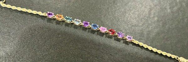 Loose multi-colored genuine sapphires set into a custom designed bracelet