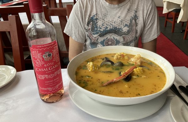 Seafood soup with wine bottle to scale.