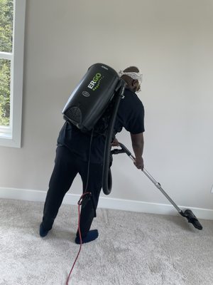 Getting every corner with backpack vacuum.