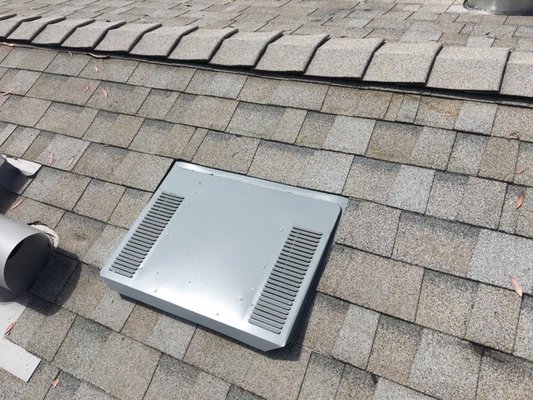 Low profile roof vent on composition shingle roof.