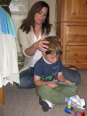 Laureen working with my son while he's distracted with toys