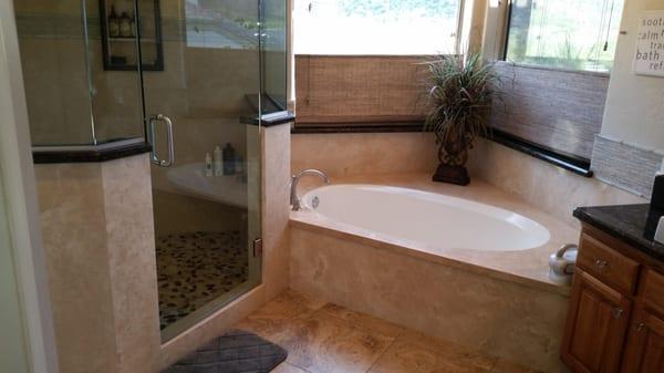 Forza Stone shower panels, granite vanity with semi-vessel sinks.