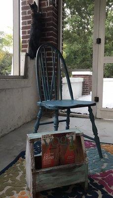 Teal blue painted chair and old shoe shine box