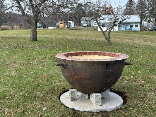 Fire pit:  cast steel bowl lined with fire brick and brick border on top