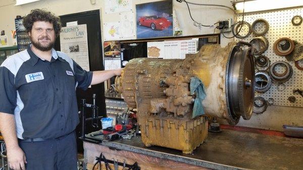 Blake standing next to a massive CAT transmission to be rebuilt!