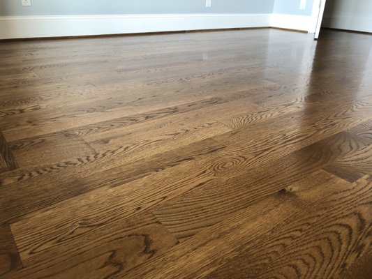 Hardwood floor refinished and stained dark walnut.