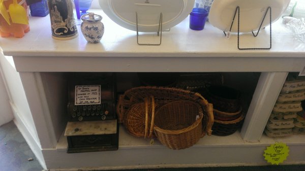 The original register tucked away with some wicker baskets