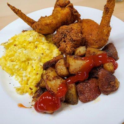 Fried chicken, homefries, and scrambled eggs.