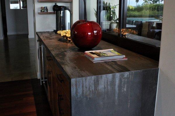 Countertops in Trilium Dekton by Cosentino. Interior wine bar countertop area finished with waterfall edge.