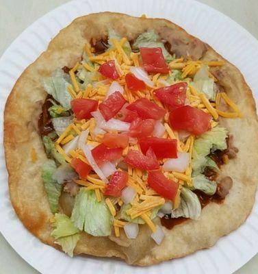 The Fry Bread Taco
Chili meat (shredded beef)
Beans
Lettuce
Onions
Tomatoes 
Cheese